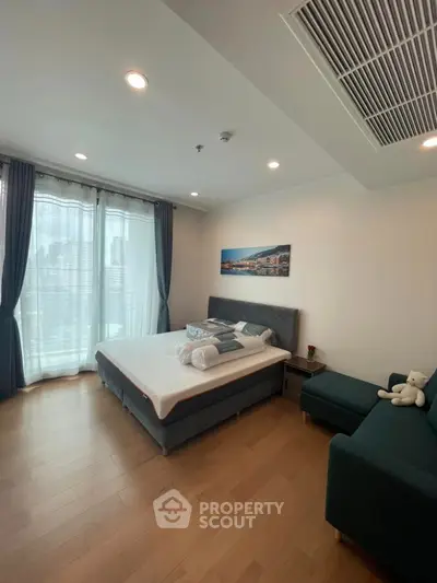 Modern bedroom with large windows and stylish decor in a luxury apartment