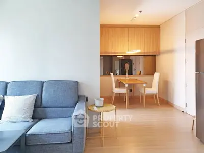Modern living room with cozy sofa and dining area in open layout apartment.