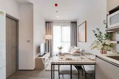 Modern living room with dining area, stylish decor, and natural light in a contemporary apartment.