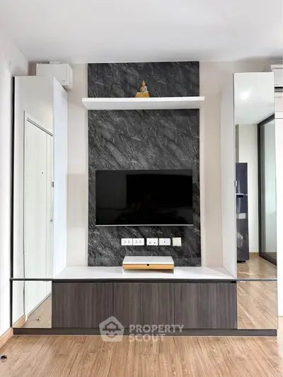 Modern living room with sleek TV unit and marble accent wall