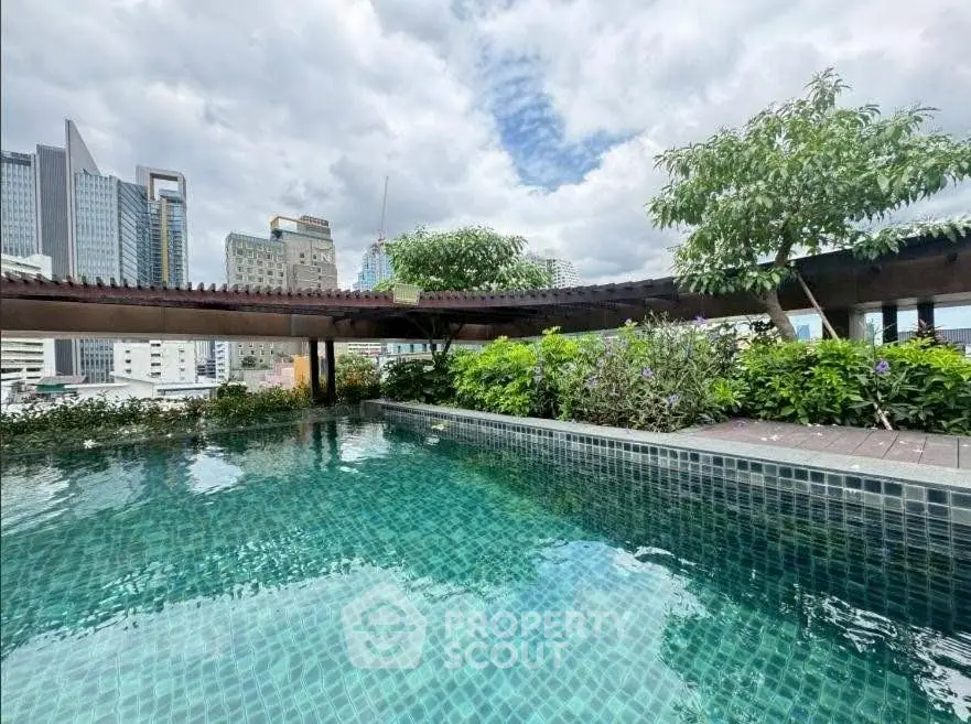 Luxurious rooftop pool with stunning cityscape views and lush greenery.