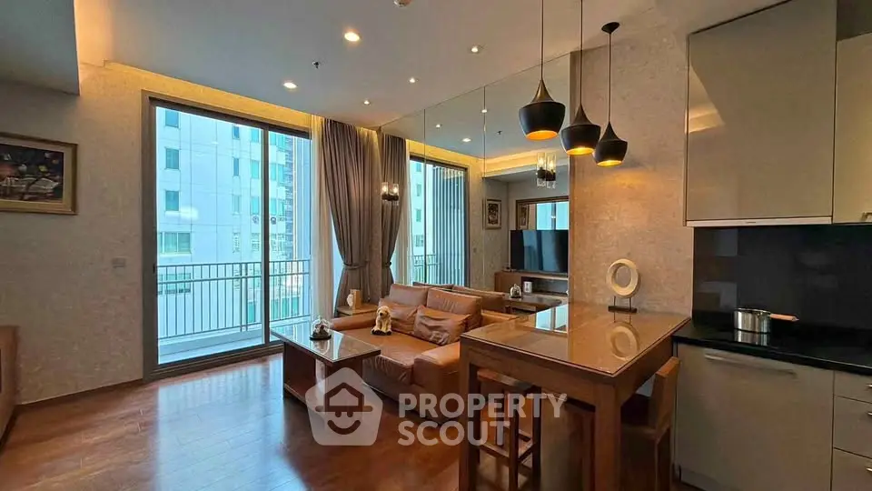 Modern living room with open kitchen and large windows in a stylish apartment