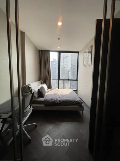 Modern bedroom with city view, sleek design and natural light
