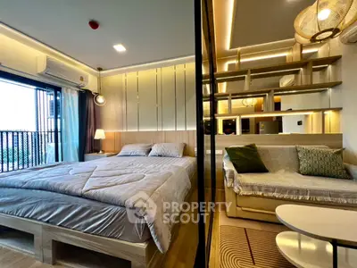 Modern bedroom with cozy bed and stylish decor, featuring a partitioned living area with a comfortable sofa.