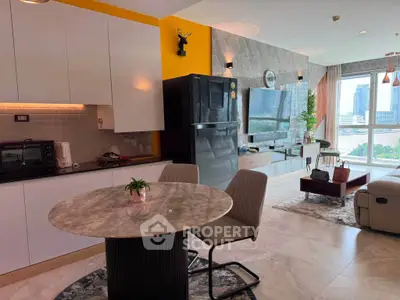 Modern open-layout living room with kitchen, featuring stylish decor and city view.