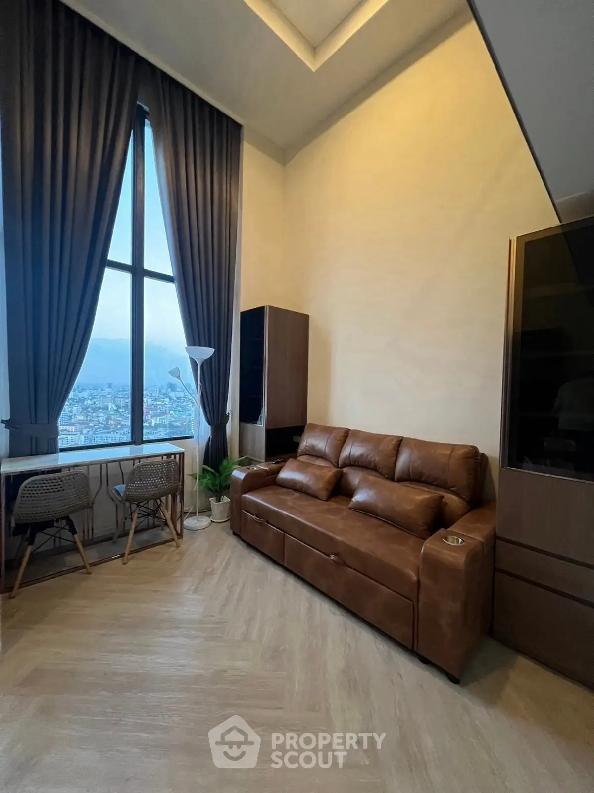 Modern living room with leather sofa and city view through large window