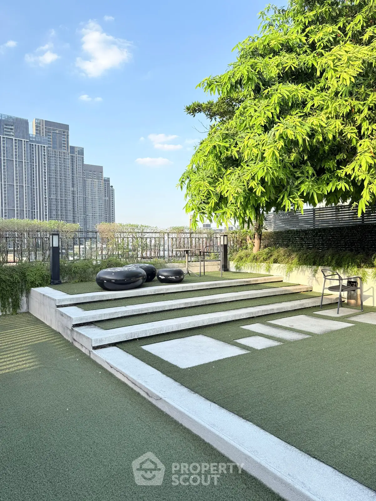Modern rooftop garden with city view and stylish seating area