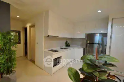Modern kitchen with sleek white cabinets and stainless steel appliances