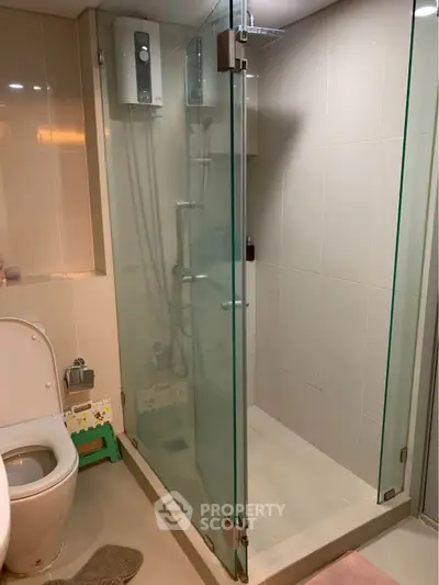 Modern bathroom with glass shower enclosure and sleek fixtures