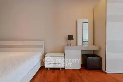 Modern bedroom with sleek furniture and hardwood flooring