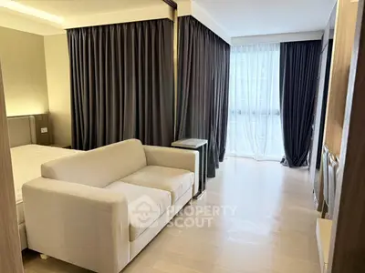 Modern bedroom with elegant curtains and cozy sofa in a stylish apartment