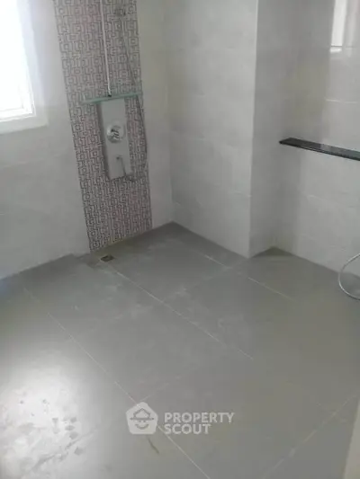 Modern bathroom with sleek tile design and built-in shower panel