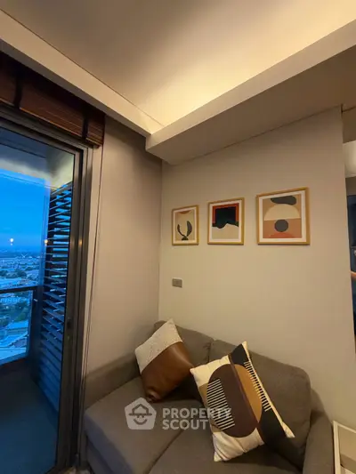 Modern living room with stylish decor and city view from balcony
