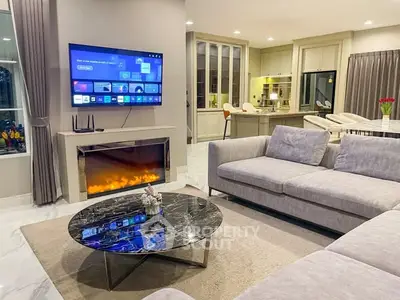 Luxurious living room with modern fireplace and open kitchen layout