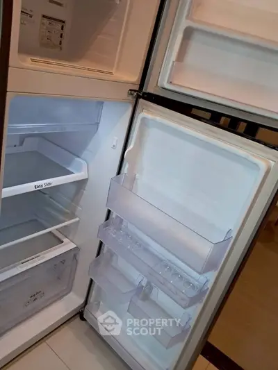 Spacious modern refrigerator with open doors showcasing ample storage space.