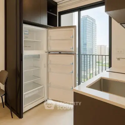 Modern kitchen with open fridge and city view from balcony