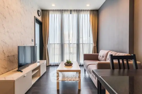Modern living room with stylish decor and large windows for natural light.