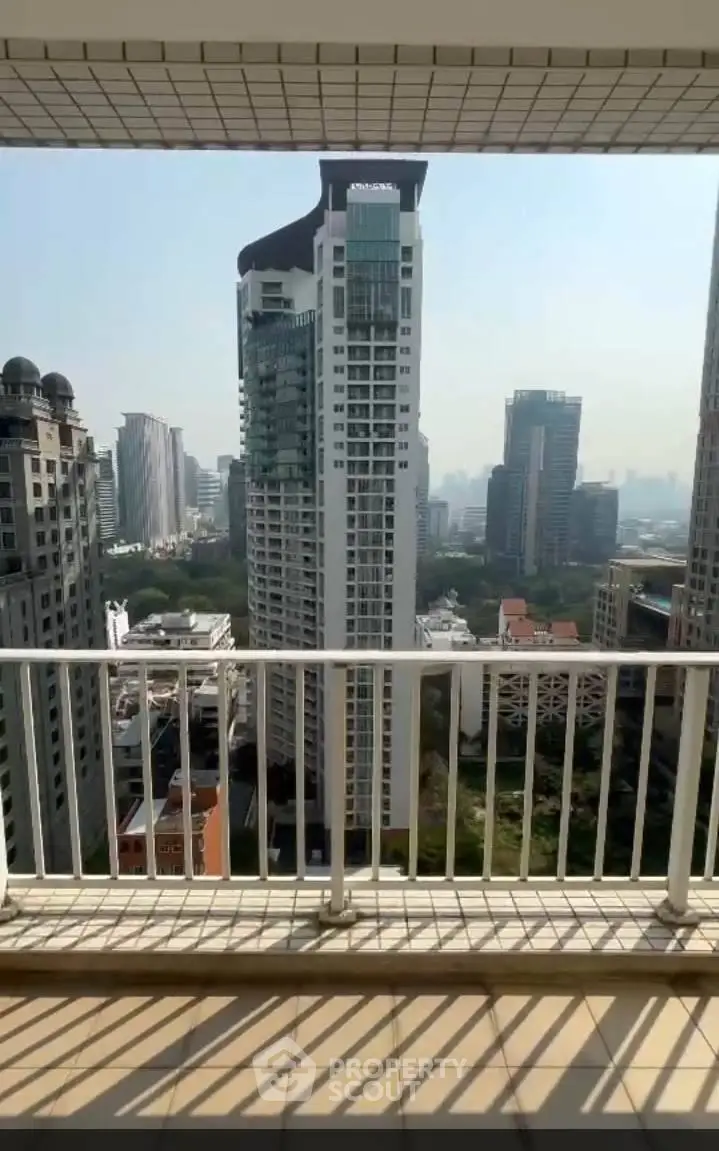 Stunning cityscape view from a high-rise balcony in a modern urban setting.