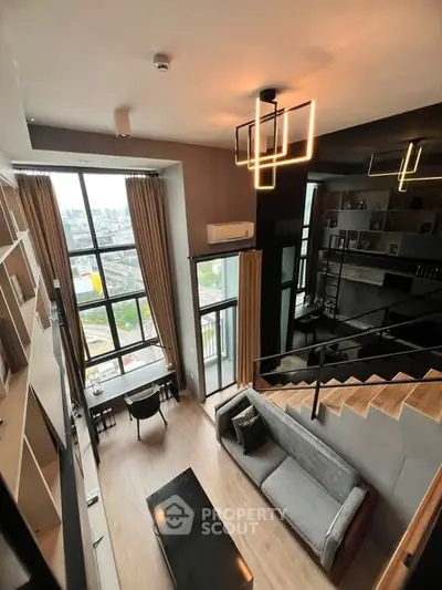 Modern loft apartment with high ceilings and large windows offering stunning city views.