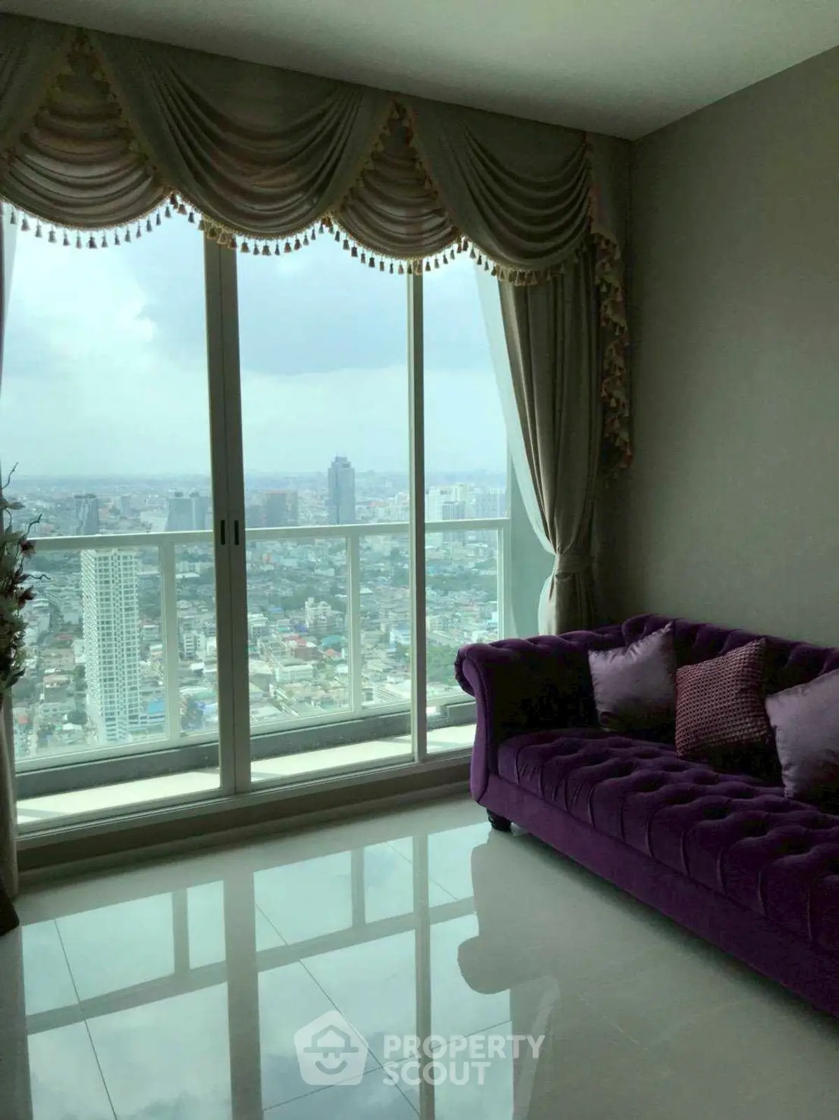 Luxurious living room with stunning city view and elegant purple sofa