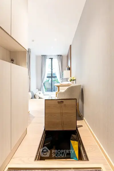 Modern apartment with hidden floor storage in bright living area.