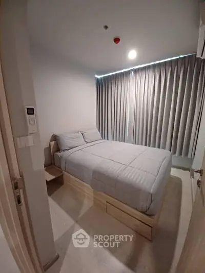 Cozy bedroom with modern decor and ample natural light, perfect for relaxation and comfort.