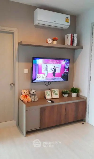 Modern living room with wall-mounted TV and stylish storage unit