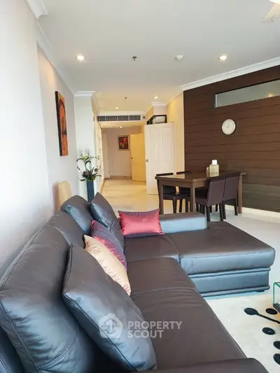 Spacious living room with modern leather sofa and elegant dining area