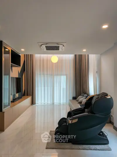 Spacious modern living room with massage chair and sleek entertainment unit