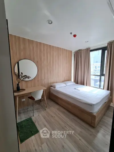 Modern bedroom with wooden accents, large window, and minimalist decor