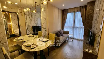 Luxurious modern living room with marble accents and elegant dining area