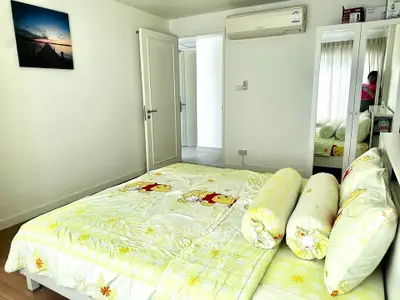 Charming bedroom with cozy Winnie the Pooh bedding and mirrored wardrobe in a bright, airy space.