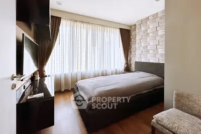 Cozy bedroom with large window and stylish decor in modern apartment