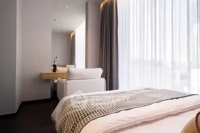 Modern bedroom with stylish decor and large window with sheer curtains