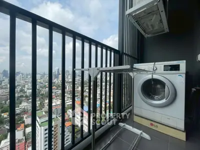 High-rise balcony with washing machine and stunning city view
