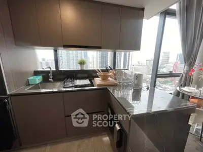 Modern kitchen with city view, featuring sleek cabinetry and marble countertops in a high-rise apartment.