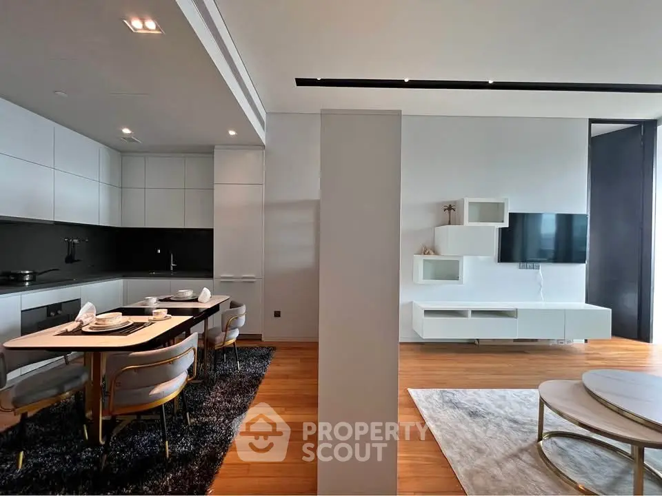 Modern open-plan living room and kitchen with sleek design and elegant furnishings.