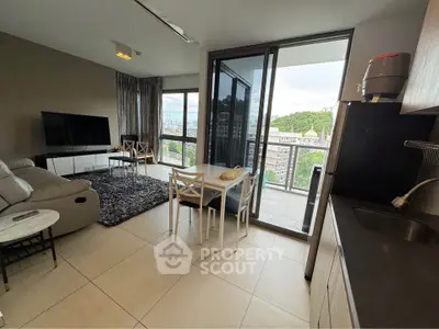 Modern open-plan living room with balcony and scenic view, featuring sleek furniture and contemporary design.