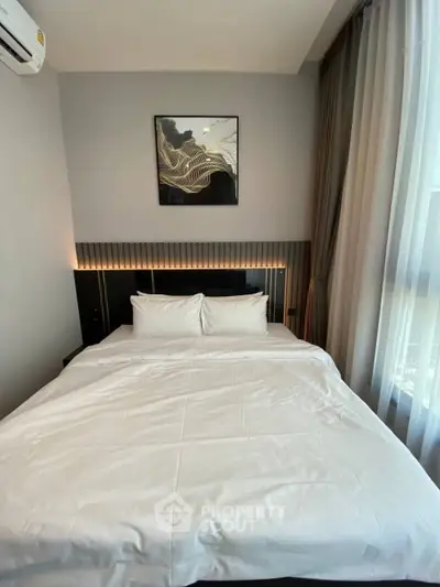 Modern bedroom with stylish decor and cozy bedding in a contemporary apartment.