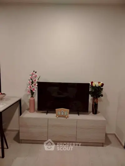 Modern living room with sleek TV stand and elegant floral decor
