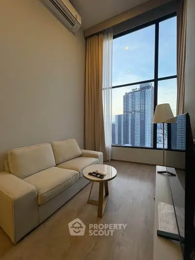 Modern living room with large window offering stunning city view, cozy sofa, and sleek decor.
