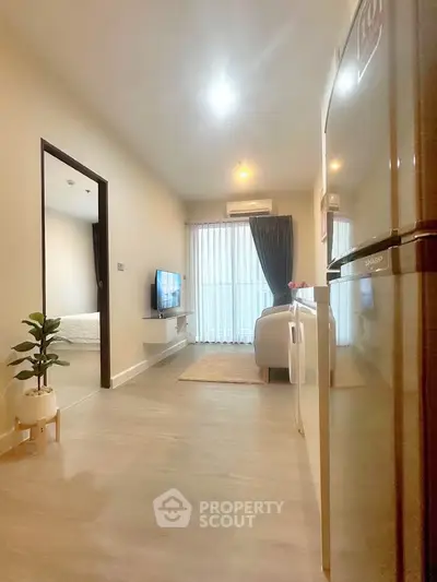 Modern apartment interior with cozy living room and bedroom, featuring stylish decor and natural light.