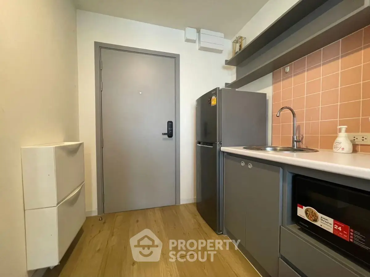 Modern compact kitchen with sleek appliances and stylish cabinetry