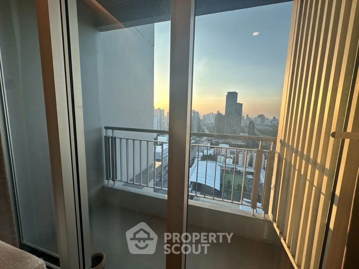 Stunning city view from a modern balcony at sunset, perfect for urban living.