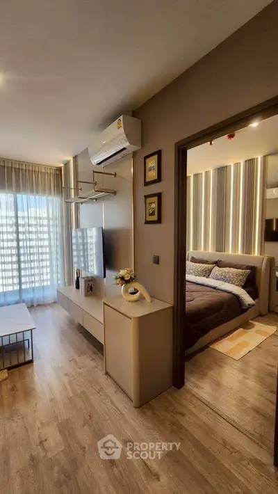 Modern living room with stylish decor and view into cozy bedroom