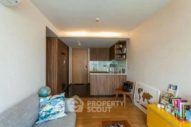 Modern living room with open kitchen and stylish decor in a cozy apartment.