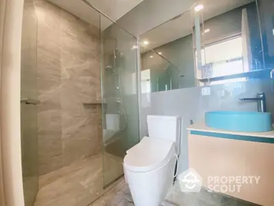 Modern bathroom with glass shower and stylish sink