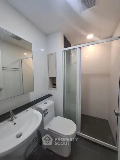 Modern bathroom with sleek fixtures and glass shower enclosure