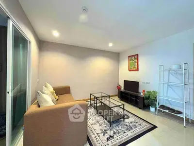 Modern living room with cozy sofa, stylish decor, and sleek TV setup in a bright, inviting space.