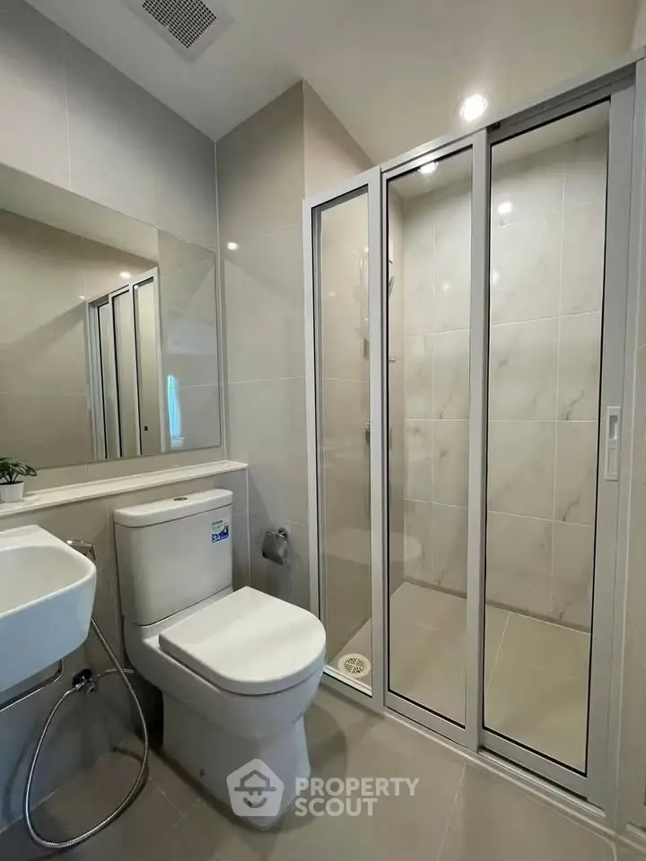 Modern bathroom with sleek shower enclosure and contemporary fixtures